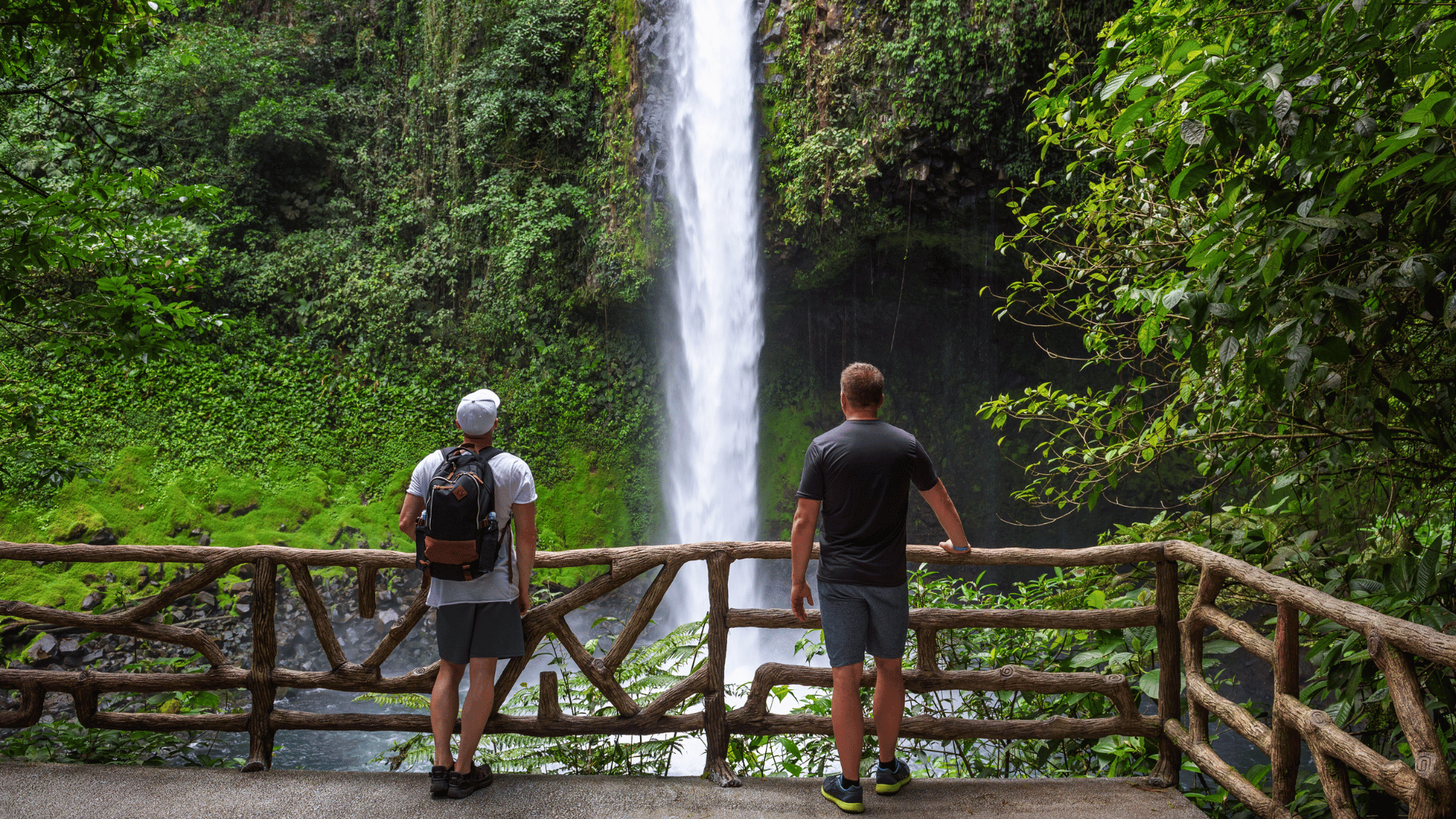 Two tourists looking at the La Fortuna Waterfall in Costa Rica